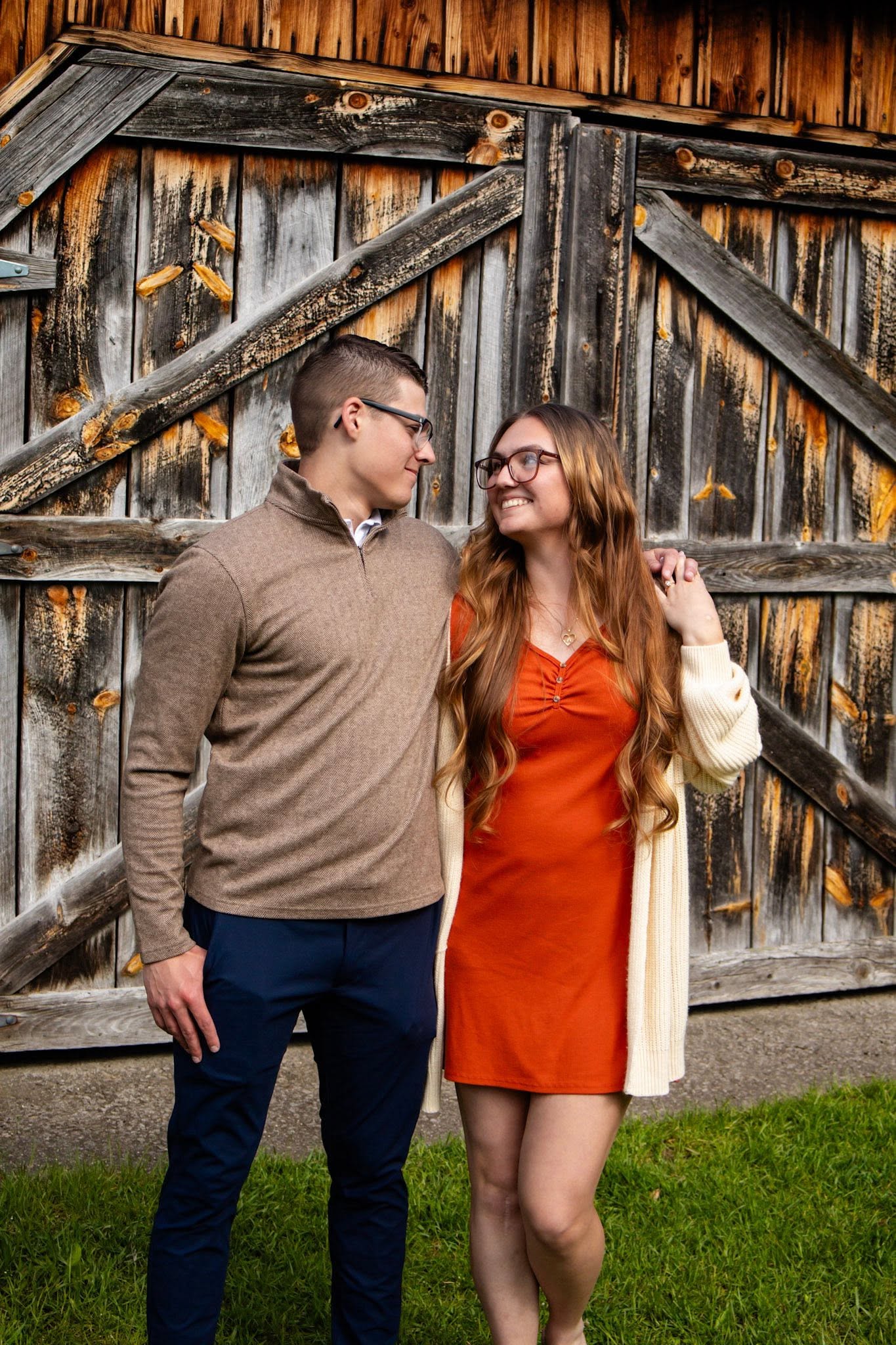 Couple laughing by a rustic barn