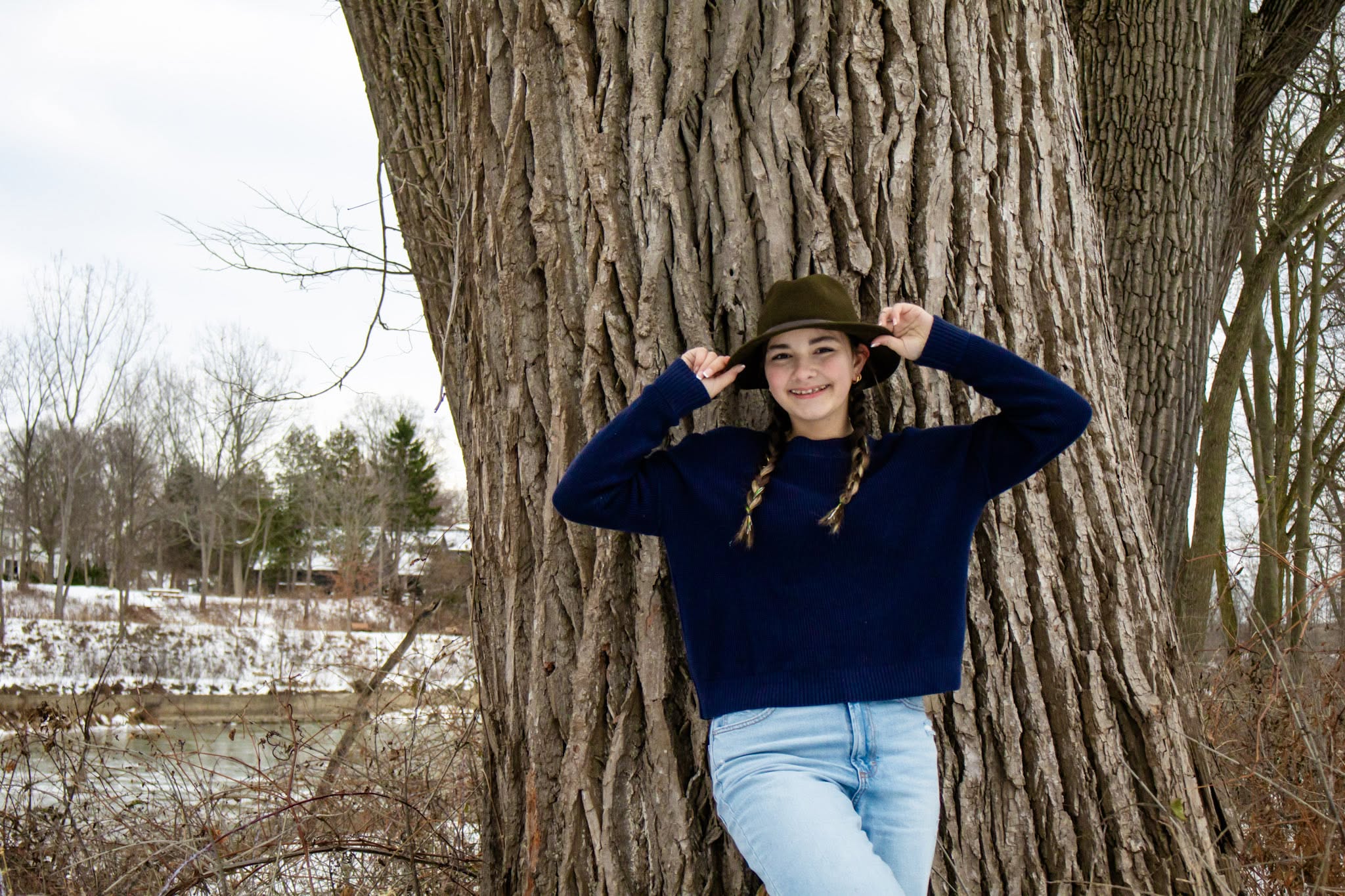 Senior in a felt hat by the water